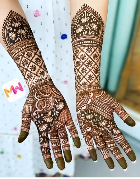 Wedding mehndi artist in Delhi creating dimensional floral check design for Indian bride at home