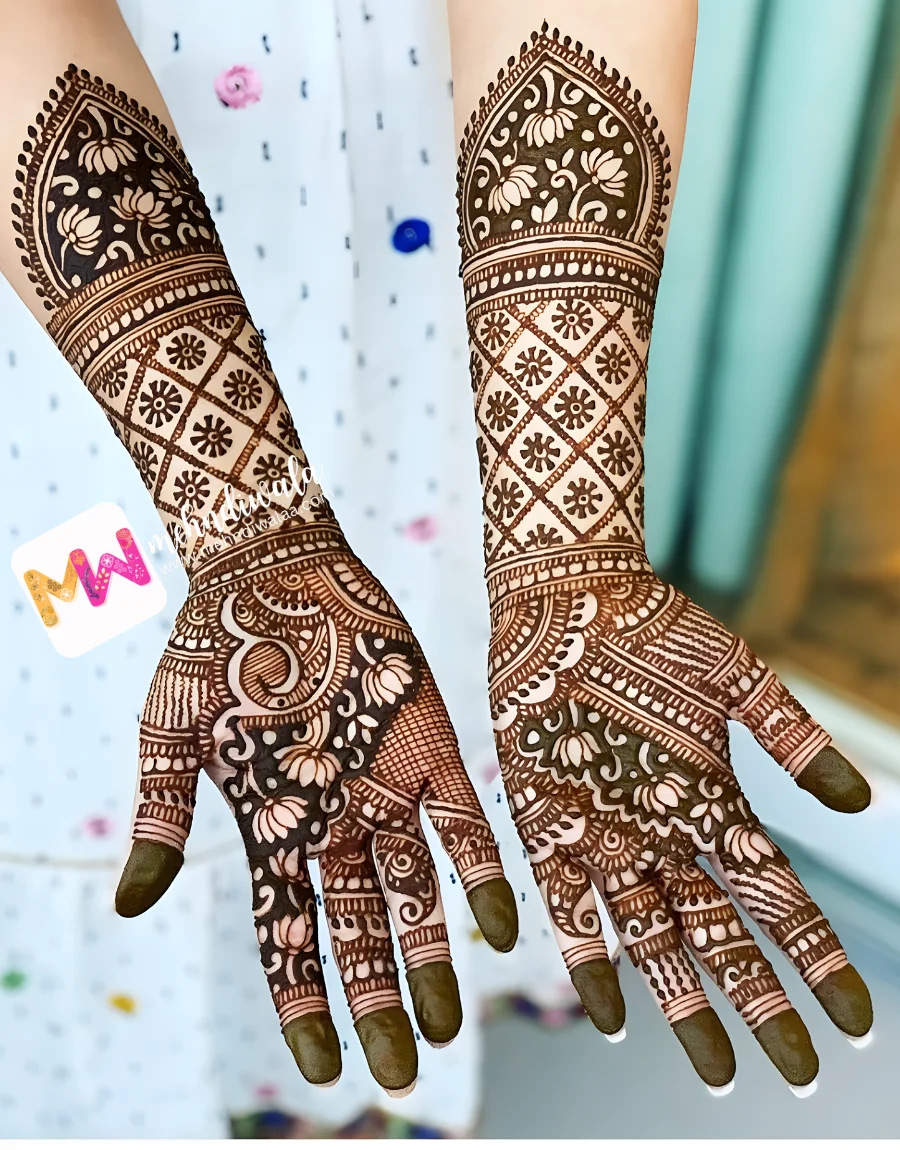 mehndi wala Wedding mehndi artist in Delhi creating dimensional floral check design for Indian bride at home